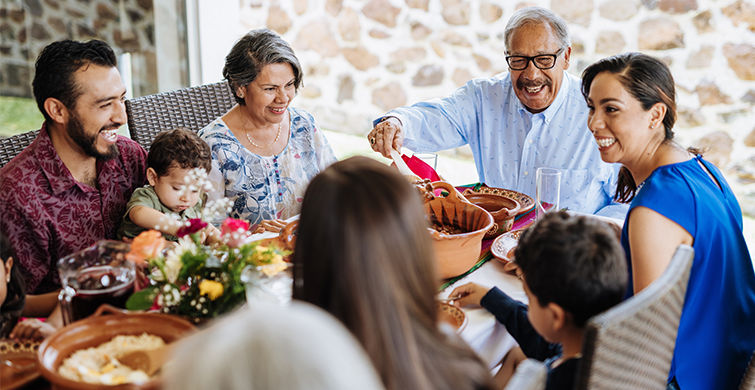 Intergenerational family enjoying a meal together.