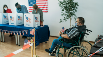 Wheelchair user waits in line to vote.