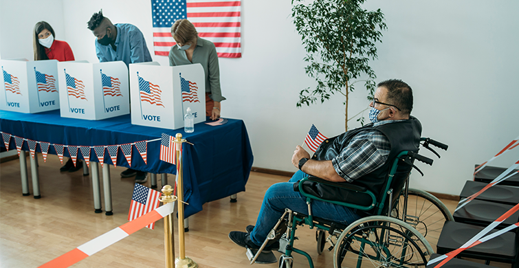 Wheelchair user waits in line to vote.