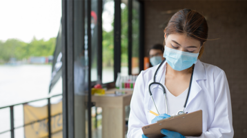 Masked doctor with clipboard