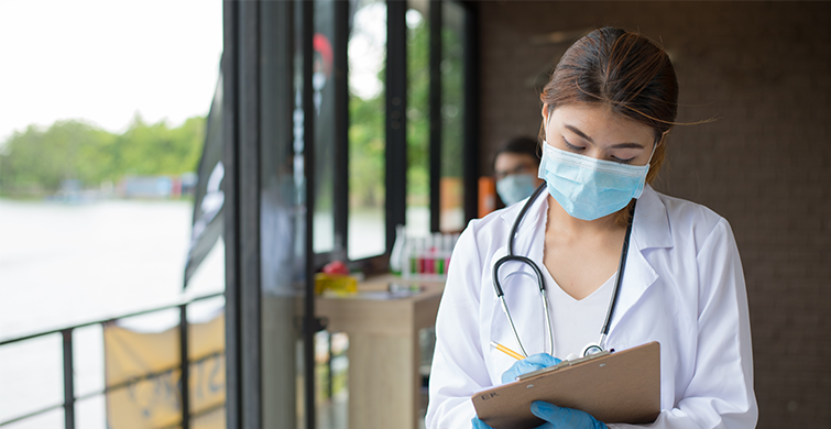 Masked doctor with clipboard