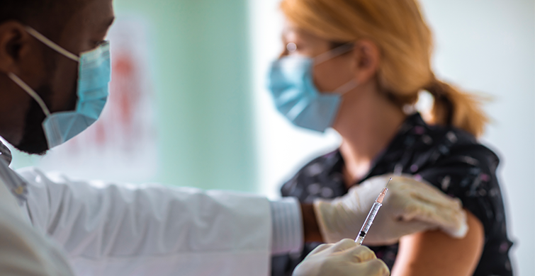 Doctor is preparing to give patient vaccine in arm