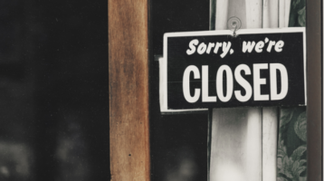 Sorry We're Closed Sign in Business Window