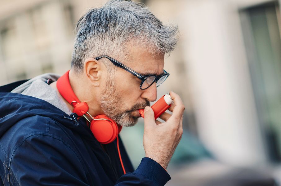 Man with Asthma using inhaler