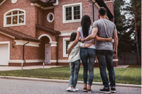 family in front of a house